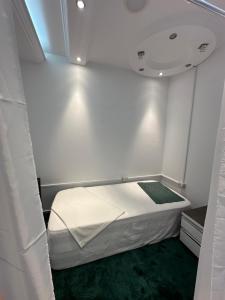 a small room with a bed in the corner at Fier Glass Apartament in Fier