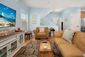 a living room with a couch and a tv at 14111 Fiesta Rd - Cape Canoe in Ocean City