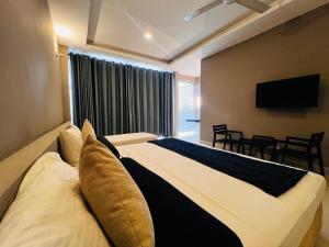 a bedroom with a large bed and a television at Oak Ray Tea Bush in Ramboda