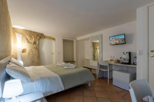 a hotel room with a bed and a kitchen at Sassolino Dimora Storica in Matera