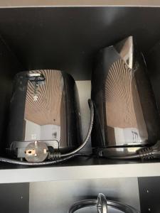 two toasters sitting on a shelf above a sink at Golden Circle Panorama Chalet in Selfoss