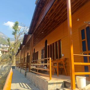 a building with a row of windows on the side of it at trigun pahadi hub in Uttarkāshi