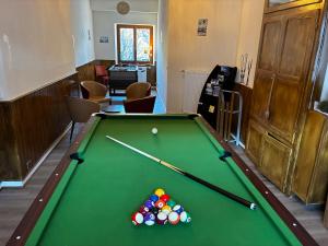a room with a pool table with balls on it at Hôtel du Centre - Restaurant Lelex'ir in Lélex