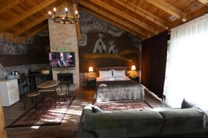 a bedroom with a bed and a living room at Eymirbungalovya in Yeşilkent +46 photos