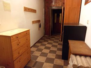 a kitchen with a checkered floor and a refrigerator at Kutloch u Trpoše in Pernink