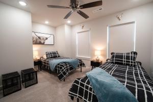 a bedroom with two beds and a ceiling fan at Back 40 Homestead - Trailside Basecamp in Bella Vista