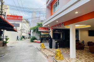 a building with yellow statues of dogs outside of it at Royal BJ Hotel in Pattaya South
