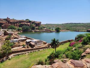 an aerial view of a river with a house at Metro Lodge in Chikmagalūr