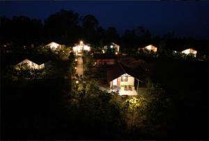 a group of houses lit up at night at Metro Lodge in Chikmagalūr +9 photos