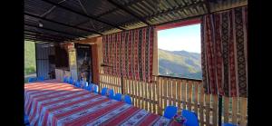 a room with a table and chairs and a window at Bardzunq Garden Resort in Goghtʼ +7 photos