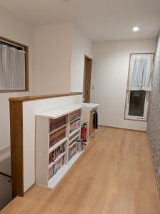 an empty room with a desk and a book shelf at わんぱくポケット in Tenjin