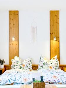 a bedroom with two beds and a chandelier at Pension a apartmány Hanna in Železná Ruda