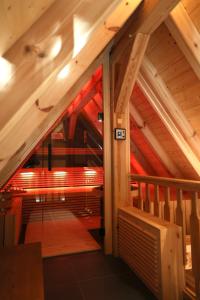 an attic room with a staircase in a building at Ferienhaus Fließ Paradies mit privatem Saunahaus - Leipe, Spreewald in Leipe