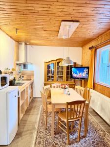 a kitchen and dining room with a table and chairs at Pension a apartmány Hanna in Železná Ruda