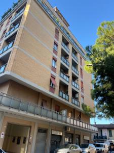a building with cars parked in front of it at Alloggio Primavera in Terni