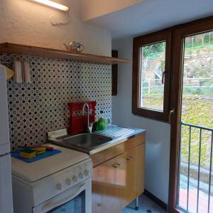 a kitchen with a sink and a stove at Fontantica di Vernazza in Vernazza +29 photos