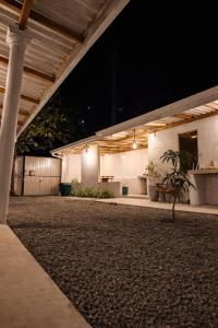 a building with a porch at night with a plant at Stara Weligama in Weligama