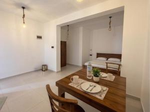 a dining room with a table and a bed at Stara Weligama in Weligama +17 photos