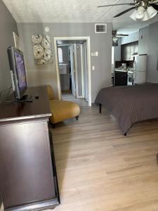 a room with a bed and a living room with a kitchen at OCEANS 735 of DEERFIELD BEACH in Deerfield Beach