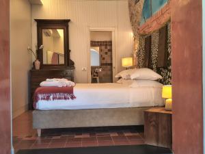 a bedroom with a large bed and a mirror at Scaglie di Mare in Manarola