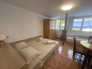 a bedroom with a large bed and a table at къща за гости ЕЛИАНИ in Gabrovo