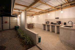 a large room with a kitchen and a table at Stara Weligama in Weligama