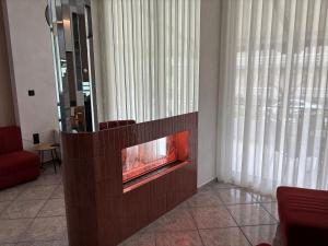 a living room with a fire place in a wall at Therma Hotel in Loutra Ipatis +32 photos