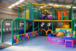 a play room with a playground with a play equipment at Wild Thistle static Caravan in Kirkcolm