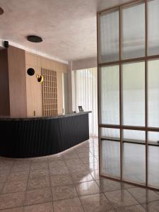 a lobby with a reception desk and glass doors at Therma Hotel in Loutra Ipatis