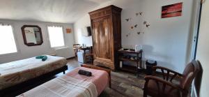 a bedroom with two beds and a wooden cabinet at SarahScope - chambre cosy avec salle de bain privée proche Futuroscope in Saint-Georges-lès-Baillargeaux