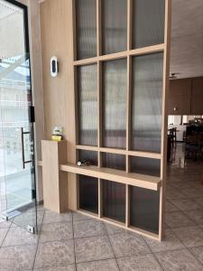 a wooden cabinet with glass shelves in a room at Therma Hotel in Loutra Ipatis