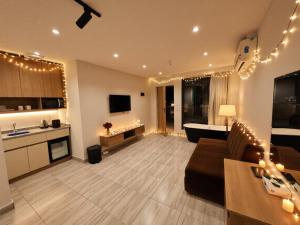 a living room with a couch and a kitchen with lights at pyramids shadow inn hotel in Cairo