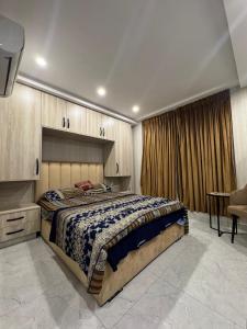 a bedroom with a large bed in a room at Stayease in Lahore