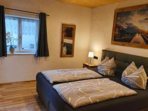 a bedroom with two beds and a window at Vorderwahllehen in Schönau am Königssee