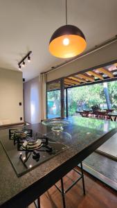 a kitchen with a counter with a stove top oven at SPA BOA VISTA - Refugio in Itatiba
