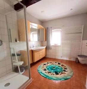 a bathroom with a shower and a pizza on the floor at Ferienwohnung am Kloster in Hornbach +24 photos