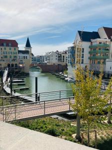 a bridge over a river in a city with buildings at Cocon Seine parisii in Sartrouville