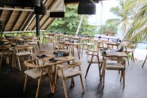 a group of tables and chairs in a restaurant at Petti Petti Beach Club- Mirissa in Mirissa