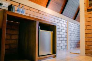 a kitchen with a refrigerator and two bottles of water at Brilliant View Cottages in Ella +16 photos