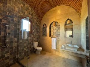 a bathroom with a sink and a toilet and a shower at Sahari house in Al Aqālitah +18 photos