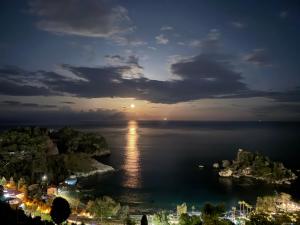 a view of the ocean at night at Paradise By The Sea in Taormina