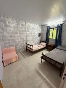 a bedroom with two beds and a brick wall at Aurora in Santiago del Estero +23 photos