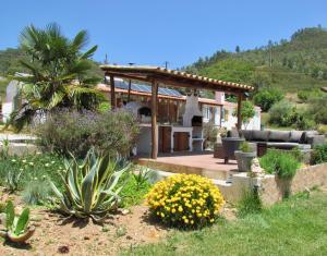 a garden with a house with a gazebo at Nova Alofa holiday home in Monchique