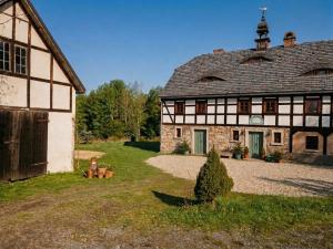 an old building with a clock on top of it at Nasze Chabazie in Olszyna