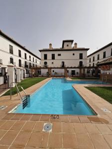 a large swimming pool in front of a building at 2 Duplex Las Terrazas Cubes in Vélez de Benaudalla