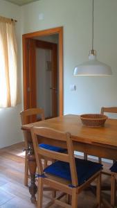 a dining room table with chairs and a bowl on it at Faial Cottage in Cedros