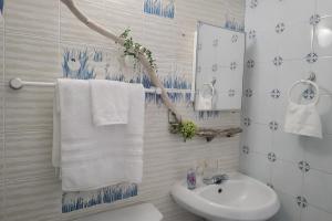 a bathroom with a sink and a mirror and towels at Dorado Costa De Oro Beach 2 Bedroom Oceanfront by Rentalspr in Dorado +3 photos