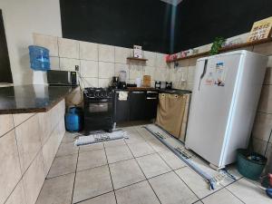 a kitchen being remodeled with a white refrigerator at Mini Hostel no centro de Tutoia in Tutóia