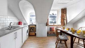 a kitchen with a table and a dining room at Bute Seaview in Rothesay