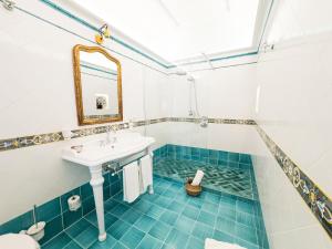 a bathroom with a sink and a mirror at Amira Capri in Anacapri